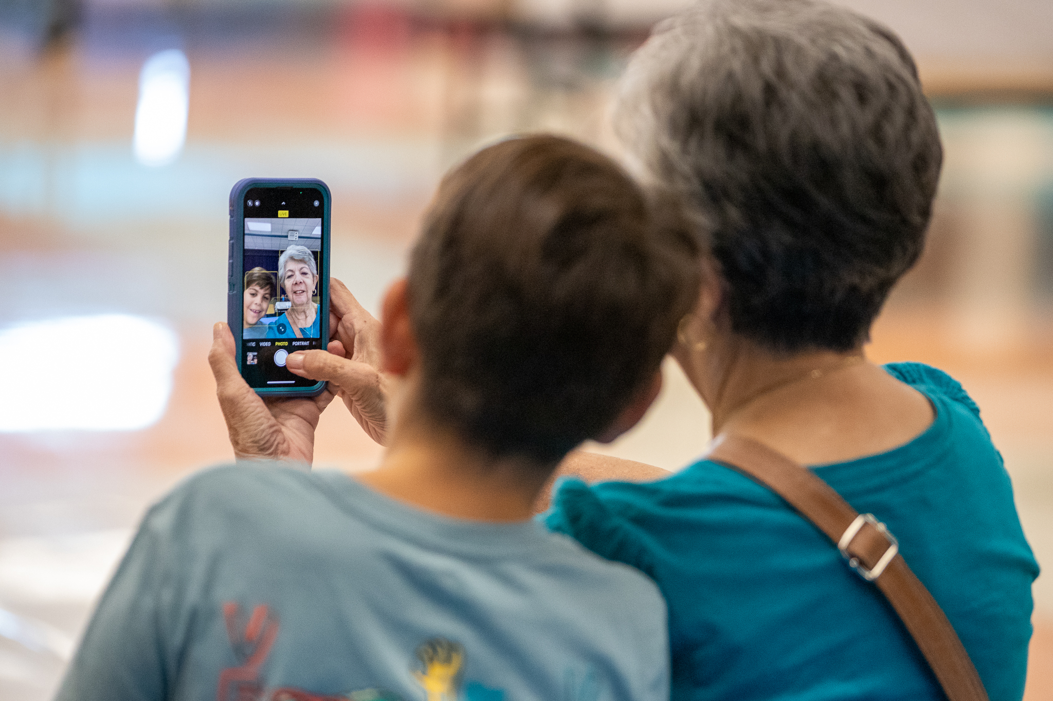 A grandmother takes a selfie with her grandson