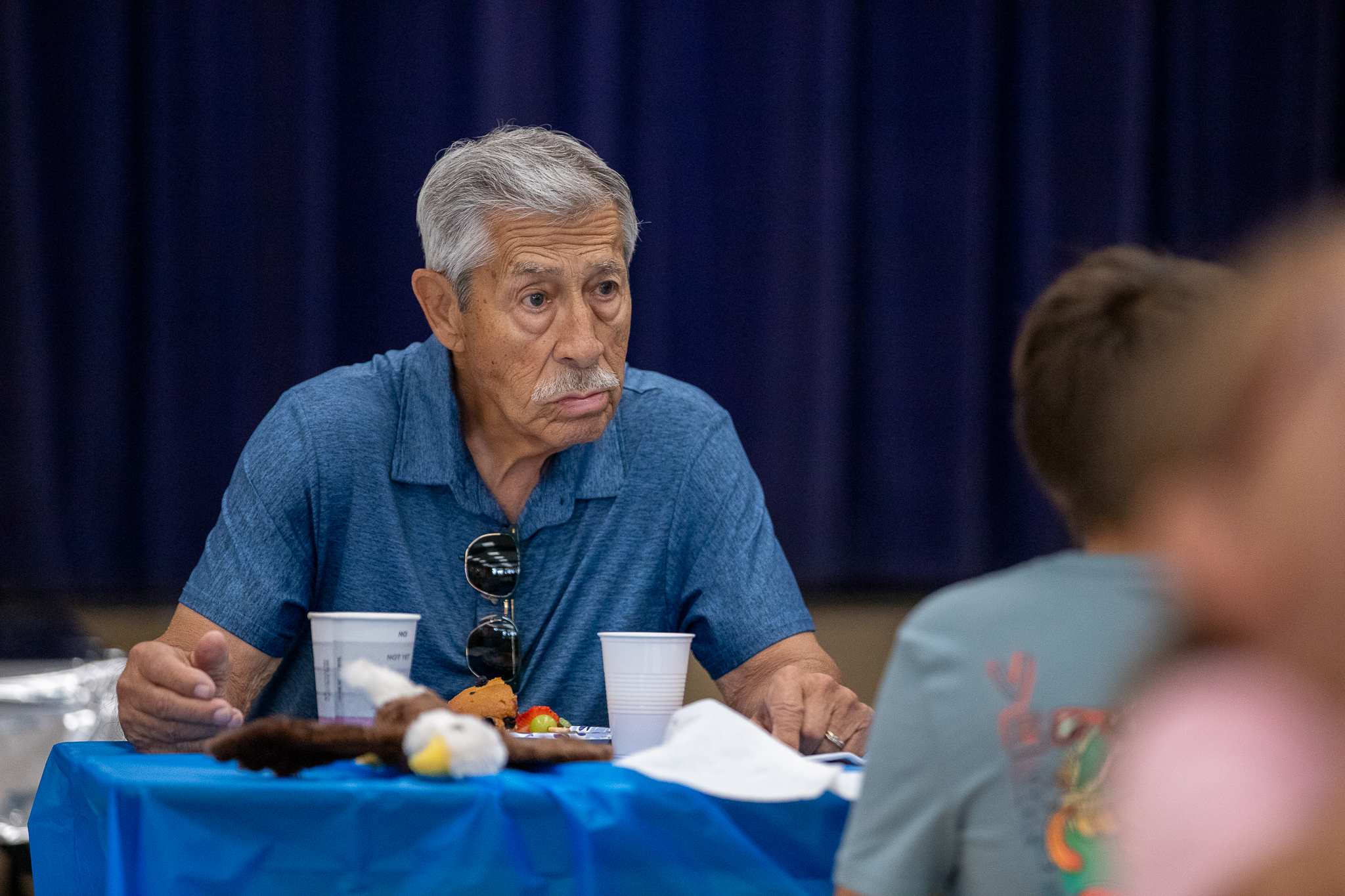 A grandpa enjoys breakfast at his table