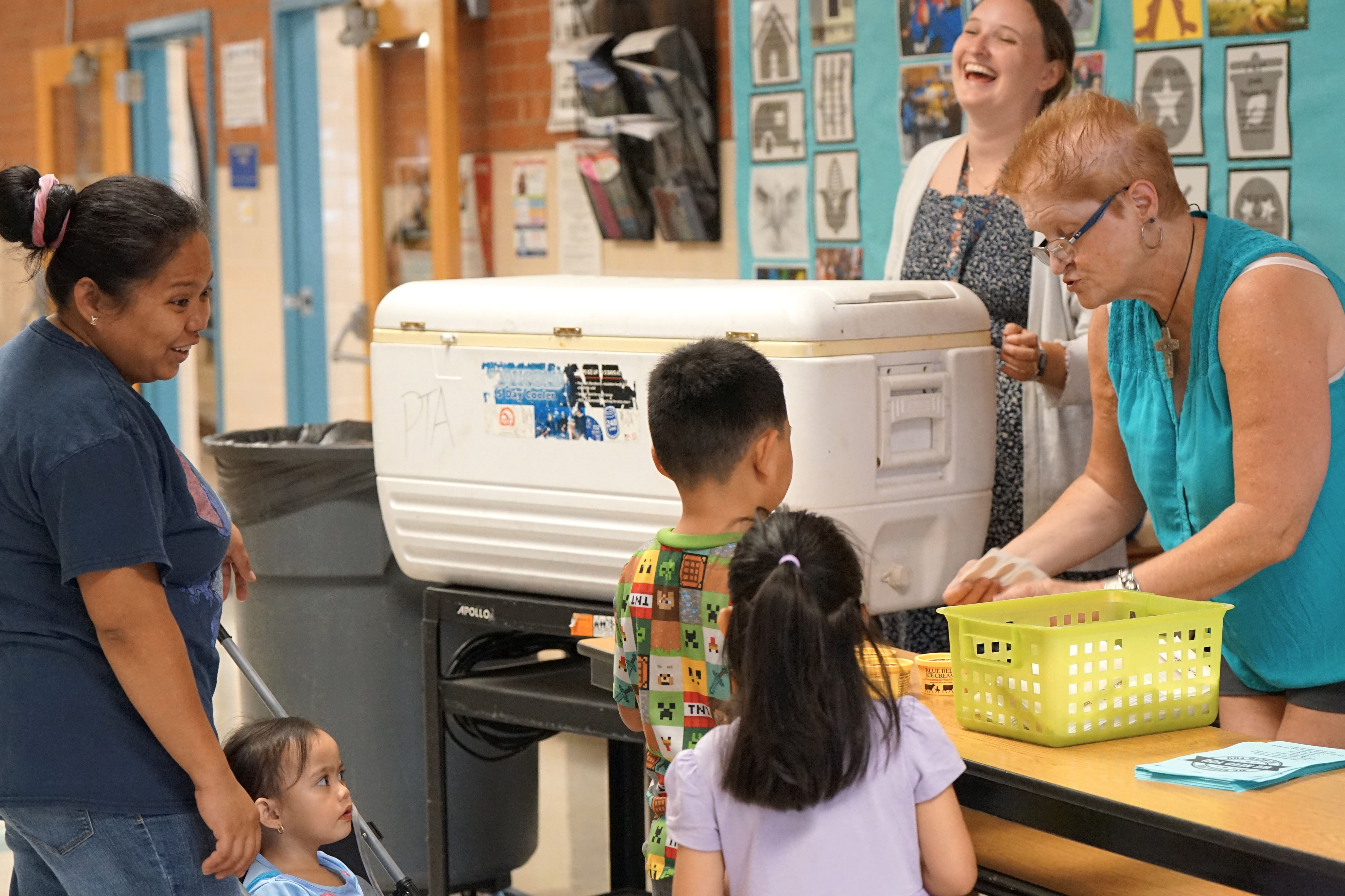 Students pick out their ice cream treats from the cooler