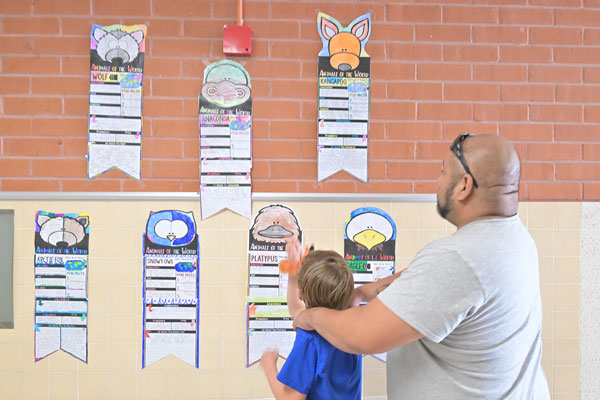 Parent and child admire the art.